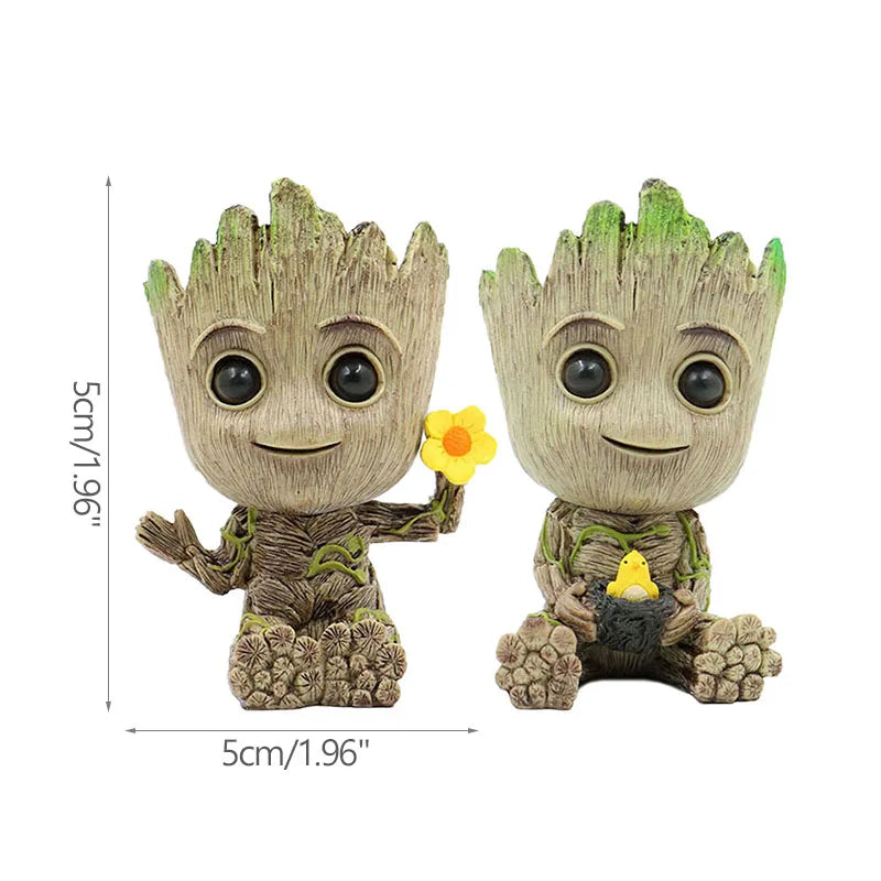 Figuras decorativas de árbol animado con ojos grandes, una sostiene flor amarilla, ideal para hogar moderno