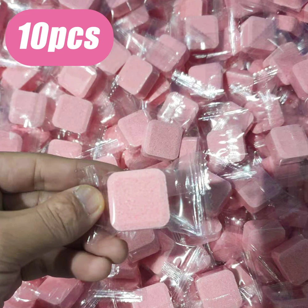 Tabletas limpiadoras cuadradas rosas en empaque individual, mano sosteniendo una, paquete de 10 piezas.